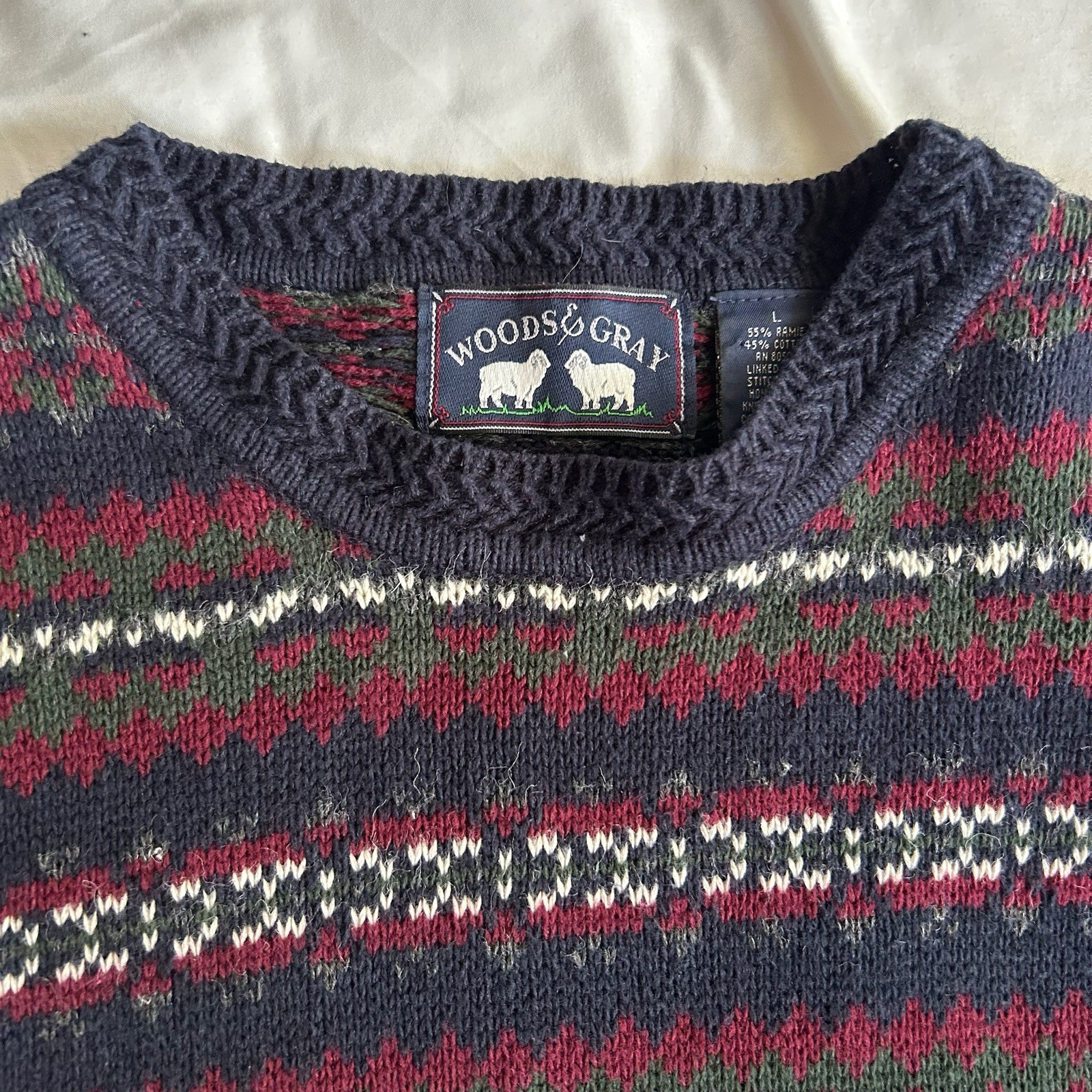 Vintage women’s fair isle sweater in red, green, navy, and white by Woods & Gray