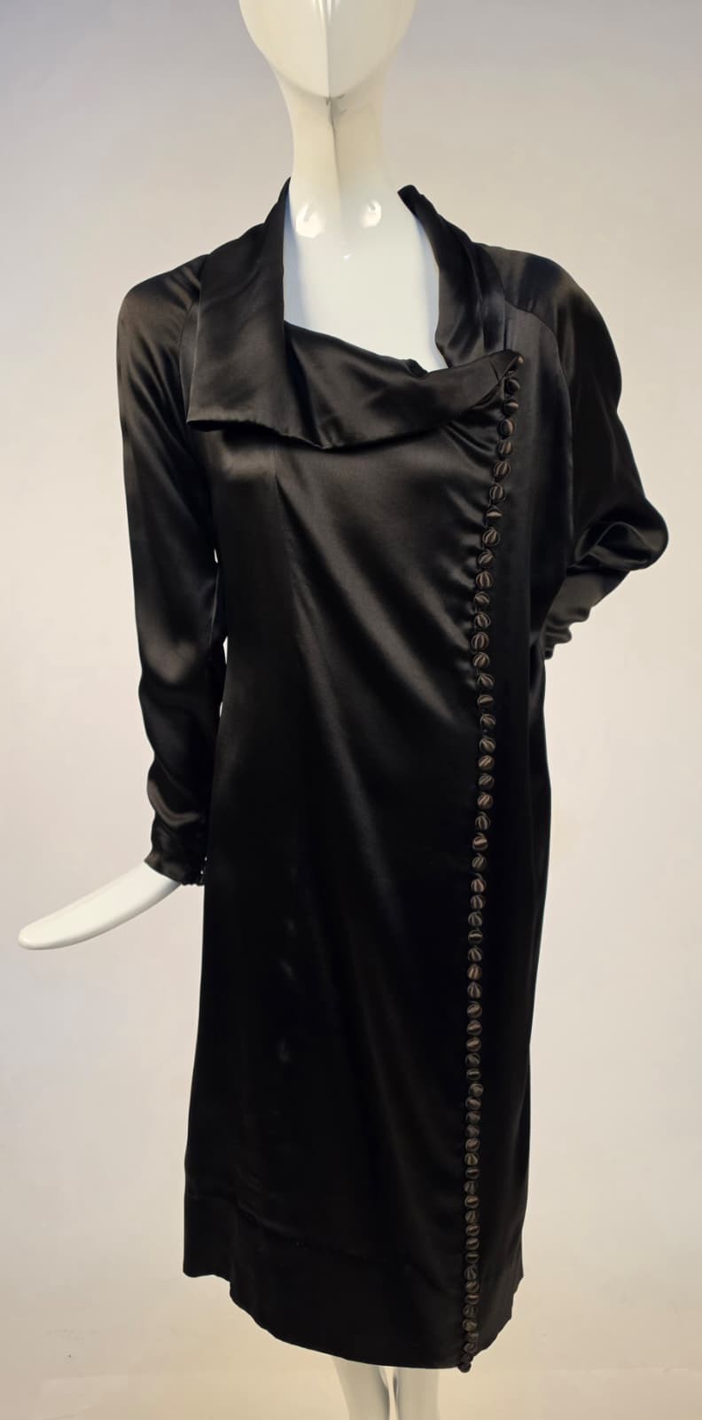 1920’S BLACK SATIN FINISH SILK DRESS W ASYMMETRICAL NECKLINE + BUTTON DETAILING