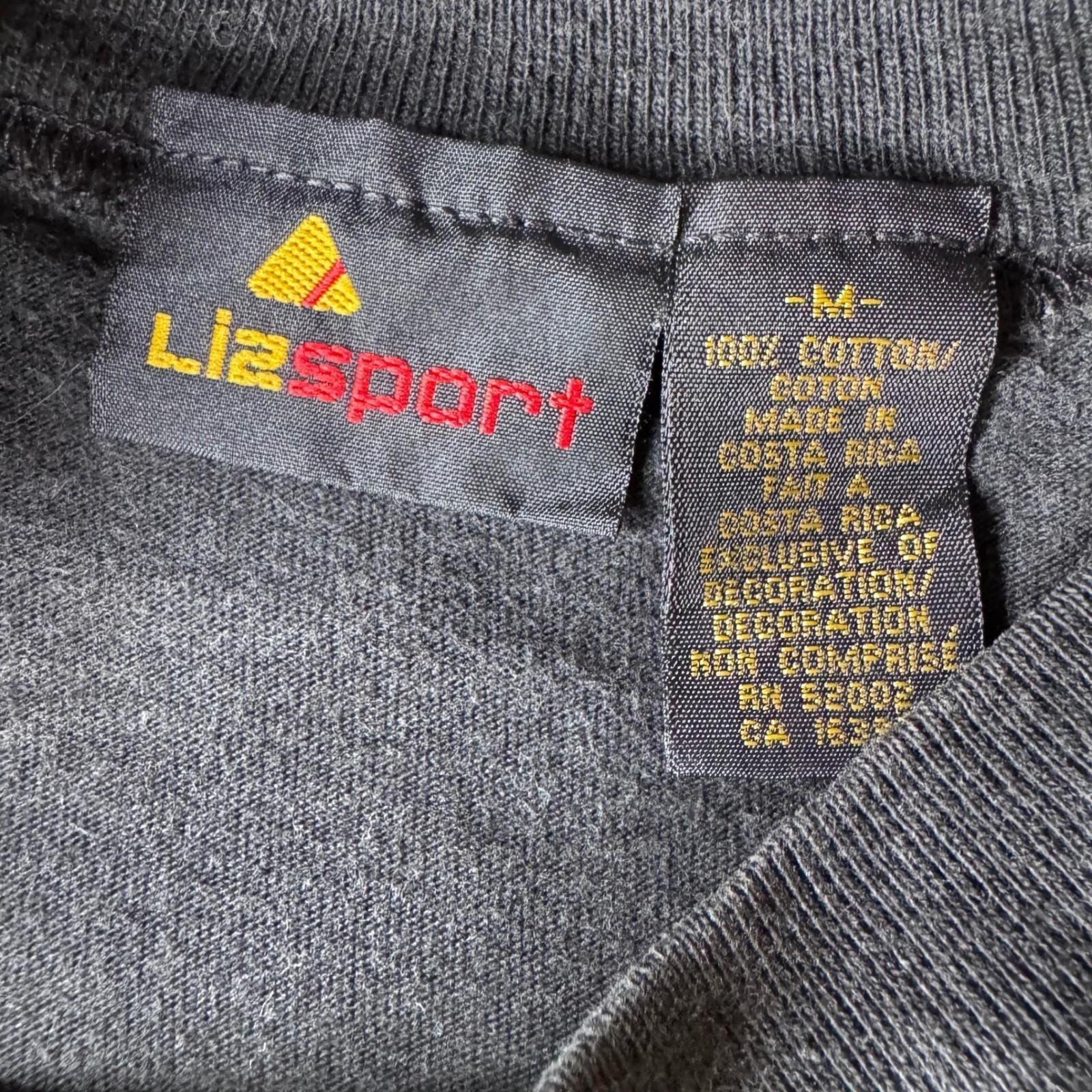 Vintage 90&rsquo;s Medium Single Stitch Black faded Liz Sport Embroidered crest tshirt